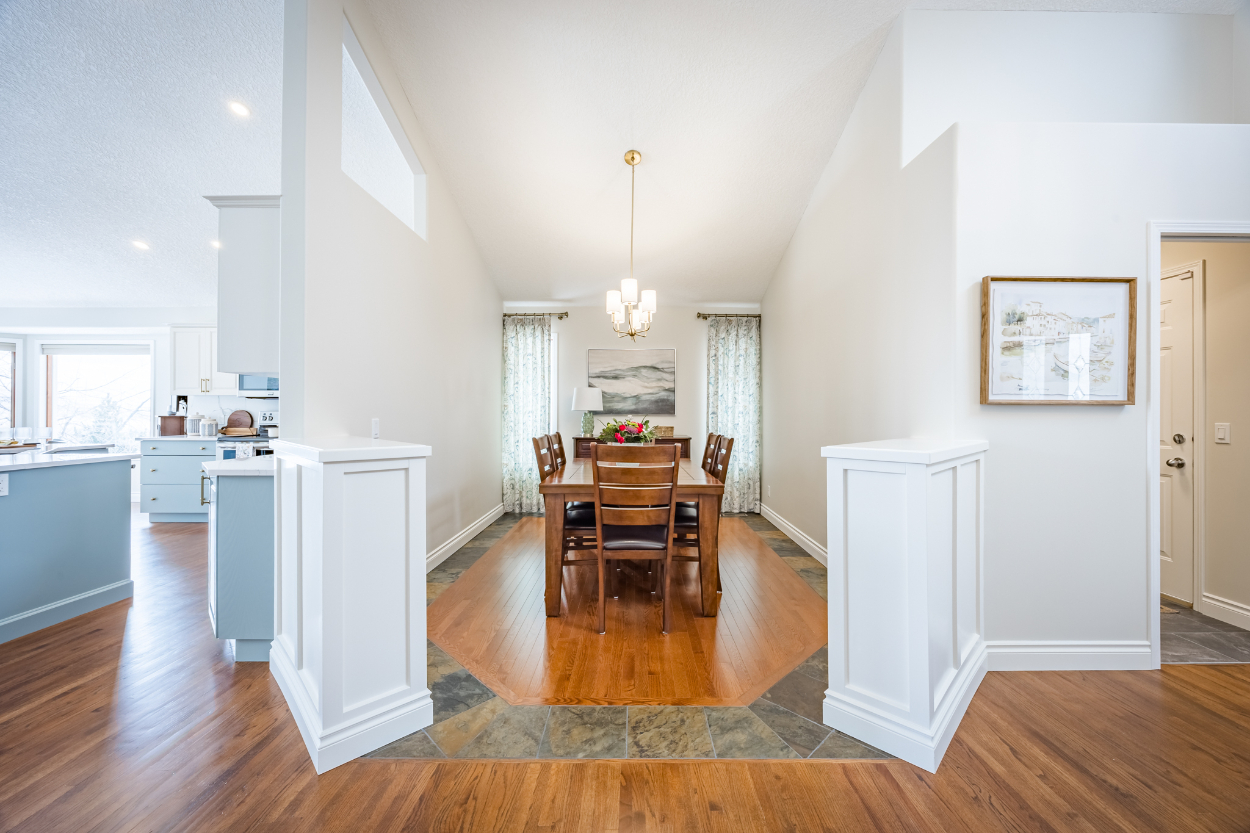 Open dining area with wide walkways, partial walls, and clear sightlines that support living in place through generous circulation and comfortable, everyday flow.