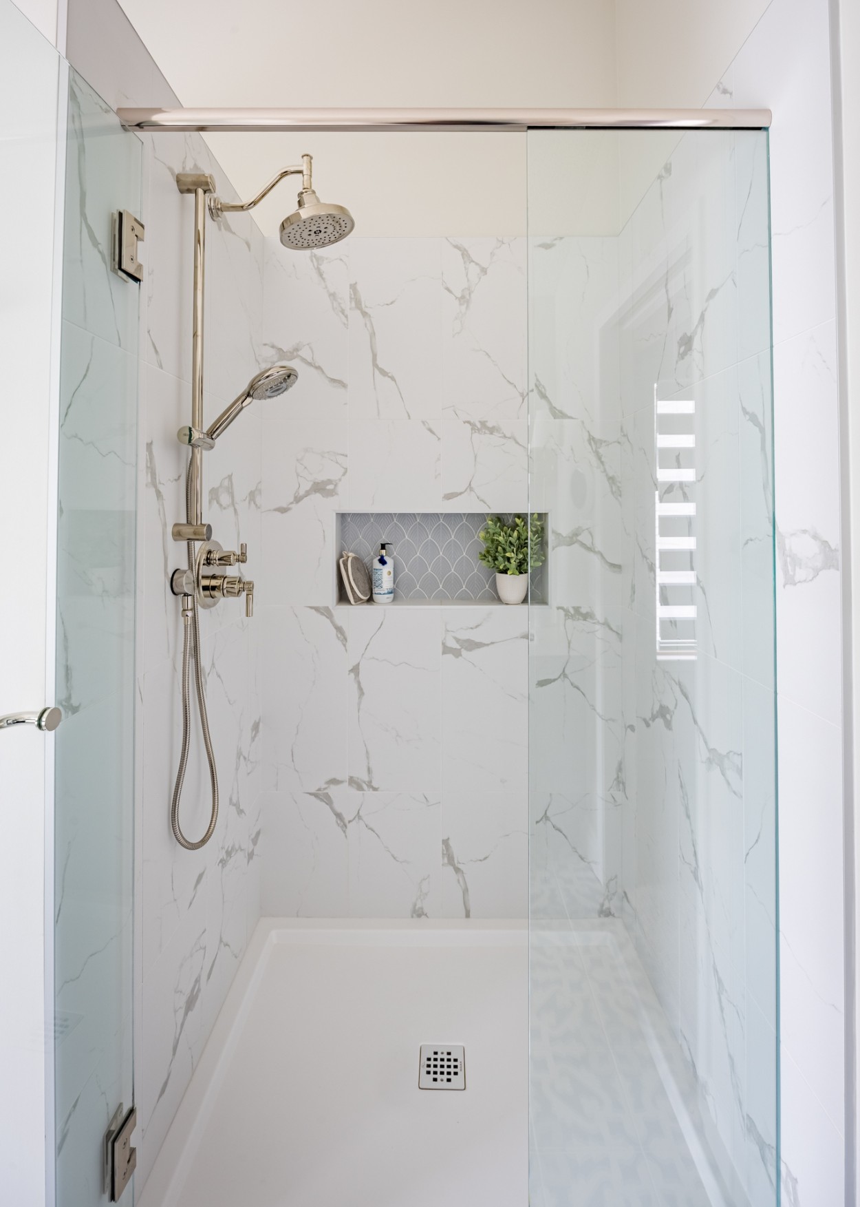 Zero-threshold shower with clean tile lines and glass enclosure, illustrating living in place design that prioritizes comfort without sacrificing style.