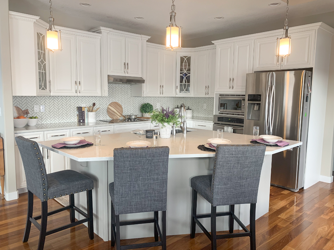 A welcoming kitchen island designed for gathering, where flow, proportion, and finishes come together through a well-planned interior design process.