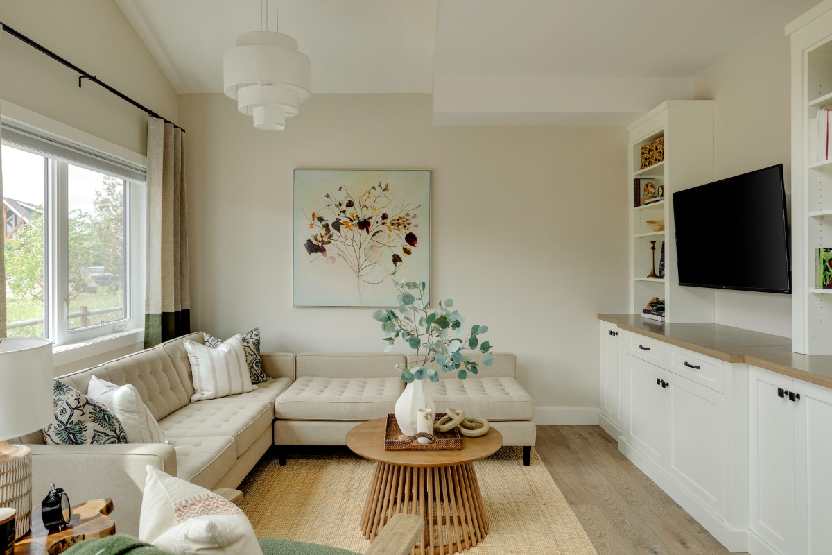 Small Cottage Club living room design with custom built-in cabinetry, neutral furnishings, and layered textures. This living area design for small spaces uses furniture scale and storage solutions to create an open, comfortable feel.
